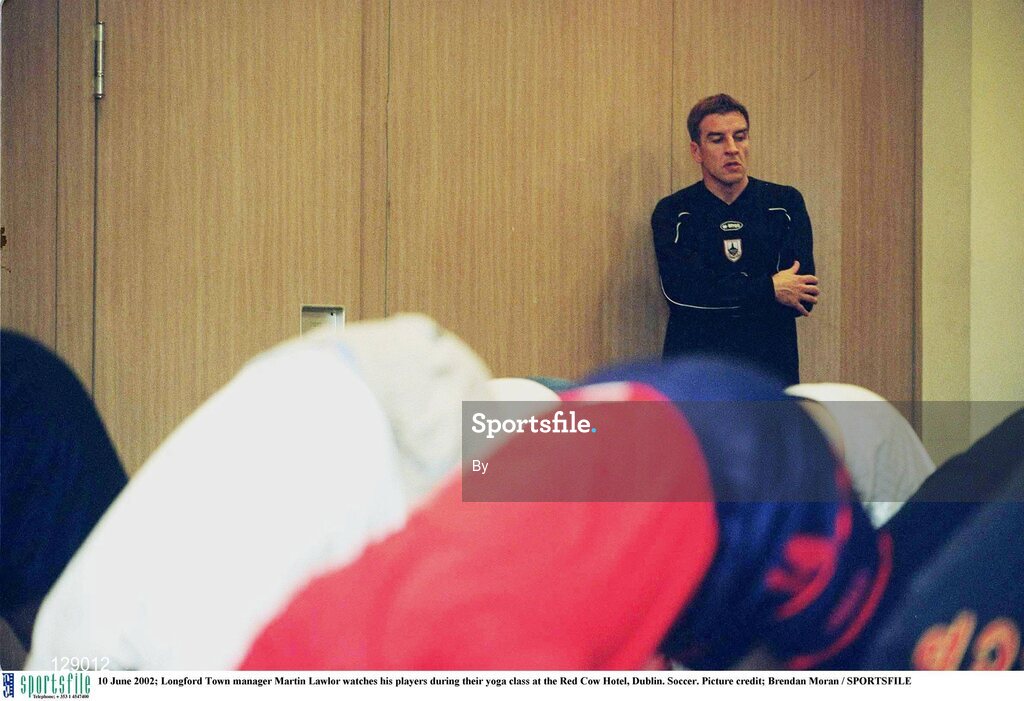 10 June 2002; Longford Town manager Martin Lawlor watches his players during their yoga class at the Red Cow Hotel, Dublin. Soccer. Picture credit; Brendan Moran / SPORTSFILE