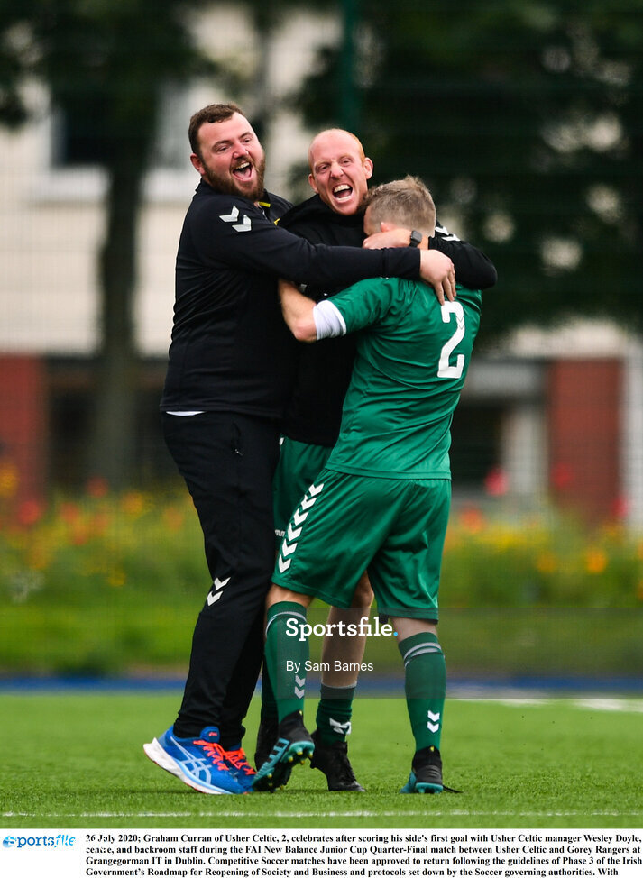 26 July 2020; Graham Curran of Usher Celtic, 2, celebrates after scoring his side's first goal with Usher Celtic manager Wesley Doyle, centre, and backroom staff during the FAI New Balance Junior Cup Quarter-Final match between Usher Celtic and Gorey Rangers at Grangegorman IT in Dublin. Competitive Soccer matches have been approved to return following the guidelines of Phase 3 of the Irish Government’s Roadmap for Reopening of Society and Business and protocols set down by the Soccer governing authorities. With games having been suspended since March, competitive games can take place with updated protocols including a limit of 200 individuals at any one outdoor event, including players, officials and a limited number of spectators, with social distancing, hand sanitisation and face masks being worn by those in attendance among other measures in an effort to contain the spread of the Coronavirus (COVID-19). Photo by Sam Barnes/Sportsfile