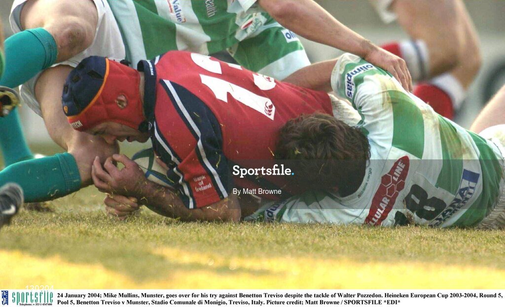 24 January 2004; Mike Mullins, Munster, goes over for his try against Benetton Treviso despite the tackle of Walter Pozzedon. Heineken European Cup 2003-2004, Round 5, Pool 5, Benetton Treviso v Munster, Stadio Comunale di Monigio, Treviso, Italy. Picture credit; Matt Browne / SPORTSFILE *EDI*