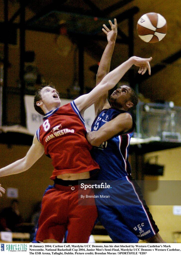 30 January 2004; Carlton Cuff, Mardyke UCC Demons, has his shot blocked by Westaro Castlebar's Mark Newcombe. National Basketball Cup 2004, Junior Men's Semi-Final, Mardyke UCC Demons v Westaro Castlebar, The ESB Arena, Tallaght, Dublin. Picture credit; Brendan Moran / SPORTSFILE *EDI*