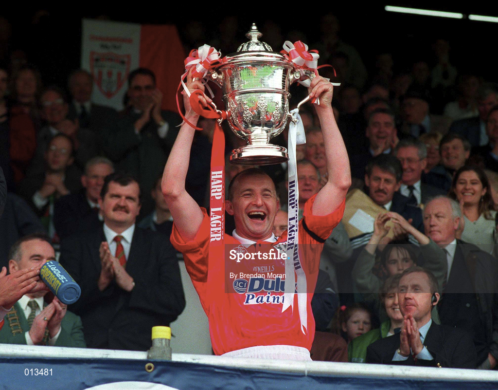 4 May 1997; Shelbourne captain Mick Neville lifts the FAI Cup, watched over by FAI Chief Executive  Bernard O'Byrne, left, following his side's victory during the FAI Cup Final match between Derry City and Shelbourne at Dalymount Park in Dublin. Photo by Brendan Moran/Sportsfile