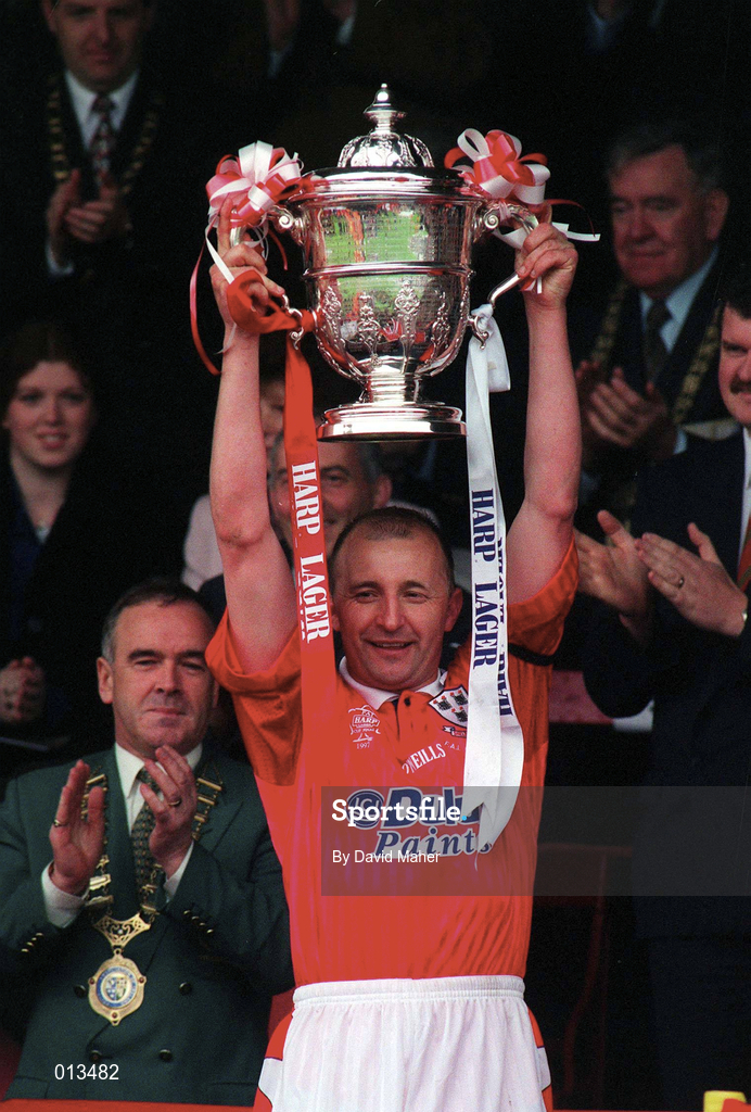 4 May 1997; Shelbourne captain Mick Neville lifts the FAI Cup, watched by FAI President Pat Quigley, left, following his side's victory during the FAI Cup Final match between Derry City and Shelbourne at Dalymount Park in Dublin. Photo by David Maher/Sportsfile