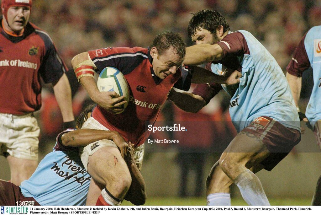 31 January 2004; Rob Henderson, Munster, is tackled by Kevin Zhakata, left, and Julien Bouic, Bourgoin. Heineken European Cup 2003-2004, Pool 5, Round 6, Munster v Bourgoin, Thomond Park, Limerick. Picture credit; Matt Browne / SPORTSFILE *EDI*