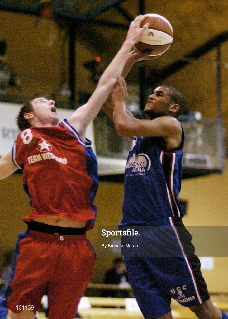 30 January 2004; Carlton Cuffe, Mardyke UCC Demons, has his shot blocked by Westaro Castlebar's Mark Newcombe. National Basketball Cup 2004, Junior Men's Semi-Final, Mardyke UCC Demons v Westaro Castlebar, The ESB Arena, Tallaght, Dublin. Picture credit; Brendan Moran / SPORTSFILE *EDI*