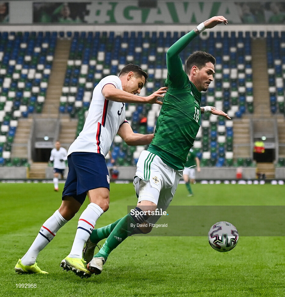 28 March 2021; Kyle Lafferty of Northern Ireland is tackled by Aaron Long of USA during the International friendly match between Northern Ireland and USA at the National Football Stadium at Windsor Park in Belfast. Photo by David Fitzgerald/Sportsfile