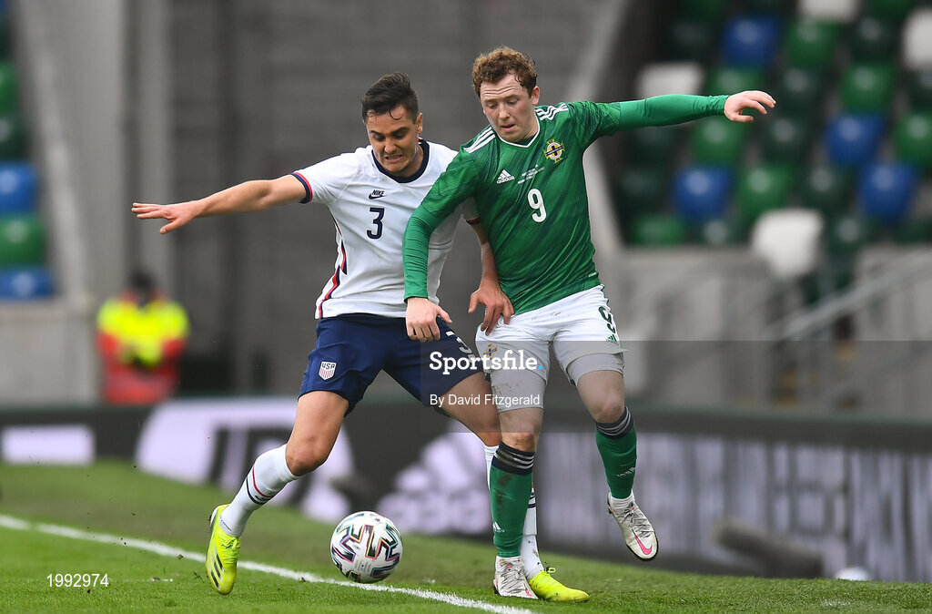 28 March 2021; Shayne Lavery of Northern Ireland in action against Aaron Long of USA during the International friendly match between Northern Ireland and USA at the National Football Stadium at Windsor Park in Belfast. Photo by David Fitzgerald/Sportsfile
