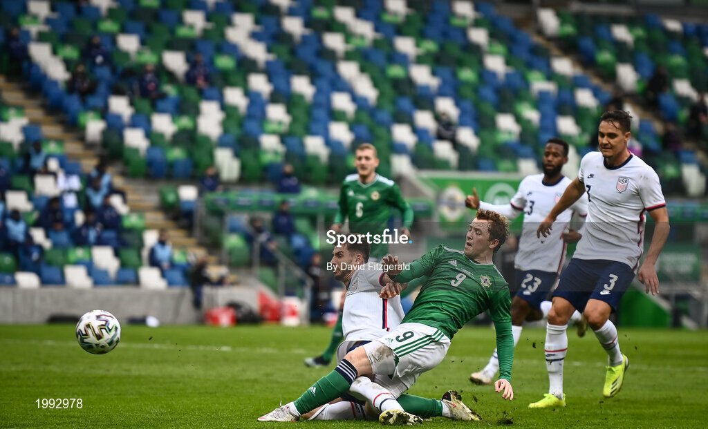 28 March 2021; Shayne Lavery of Northern Ireland shoots at goal, despite the efforts of Aaron Long of USA during the International friendly match between Northern Ireland and USA at the National Football Stadium at Windsor Park in Belfast. Photo by David Fitzgerald/Sportsfile