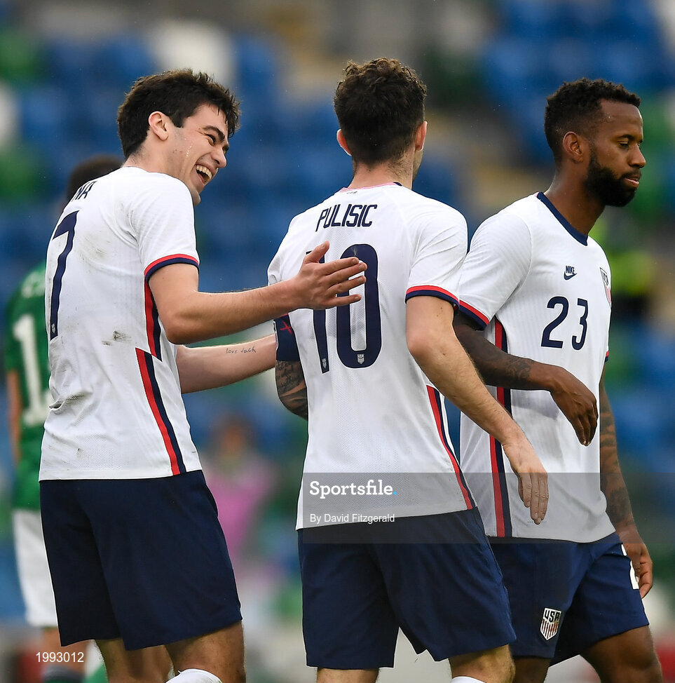 28 March 2021; Christian Pulišic, 10, of USA is congratulated by teammate Giovanni Reyna, left, and Kellyn Acosta, after scoring his side's second goal from a penalty during the International friendly match between Northern Ireland and USA at the National Football Stadium at Windsor Park in Belfast. Photo by David Fitzgerald/Sportsfile