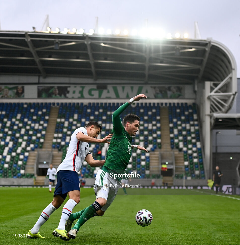 28 March 2021; Kyle Lafferty of Northern Ireland is tackled by Aaron Long of USA during the International friendly match between Northern Ireland and USA at the National Football Stadium at Windsor Park in Belfast. Photo by David Fitzgerald/Sportsfile