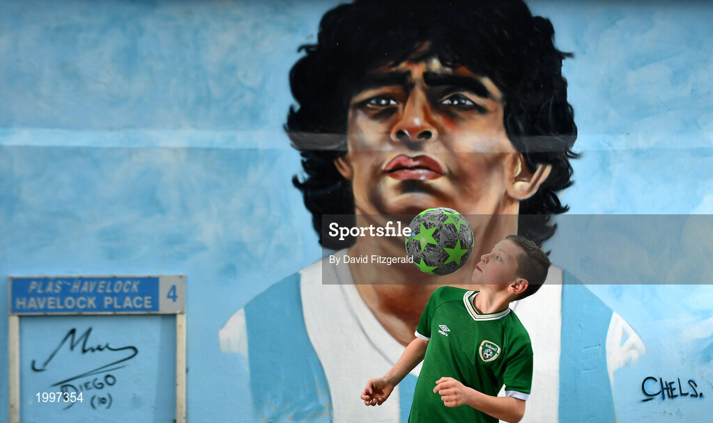 12 April 2021; Local resident Johnny Figo Murphy, age 9, from Dublin shows his skills in front of a mural by Dublin artist Chelsea Jacobs depicting the late Argentine footballer Diego Maradona at Havelock Square in Dublin. Photo by David Fitzgerald/Sportsfile