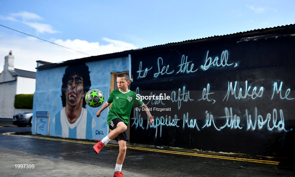 12 April 2021; Local resident Johnny Figo Murphy, age 9, from Sandymount in Dublin practices his skills in front of a mural by Dublin artist Chelsea Jacobs depicting the late Argentine footballer Diego Maradona at Havelock Square in Dublin. Photo by David Fitzgerald/Sportsfile