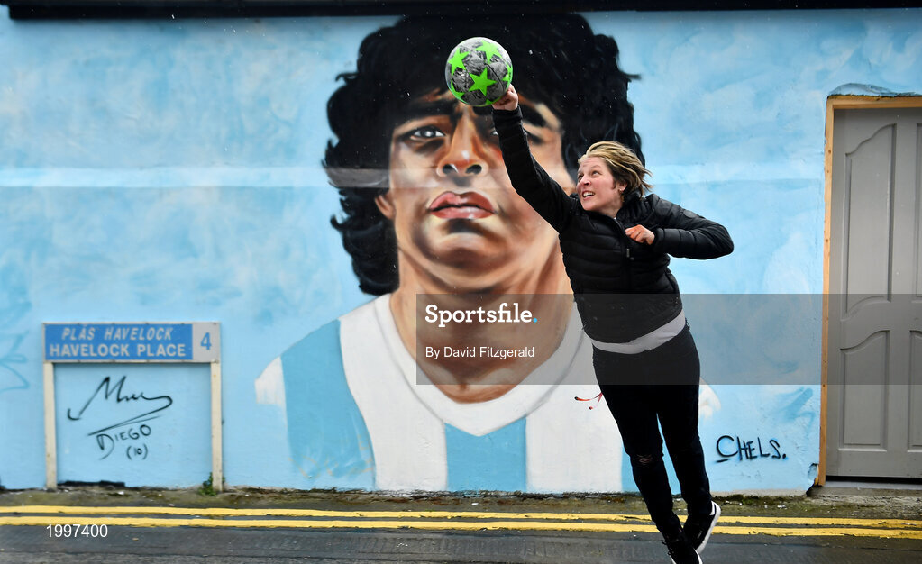 12 April 2021; Dublin artist Chelsea Jacobs immitates the famous 'hand of God' in front of her mural depicting the late Argentine footballer Diego Maradona at Havelock Square in Dublin. Photo by David Fitzgerald/Sportsfile
