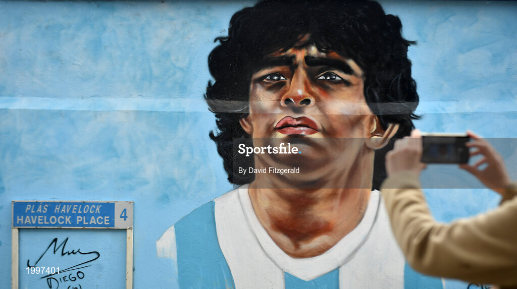 12 April 2021; A passer-by takes a photo of a mural by Dublin artist Chelsea Jacobs depicting the late Argentine footballer Diego Maradona at Havelock Square in Dublin. Photo by David Fitzgerald/Sportsfile