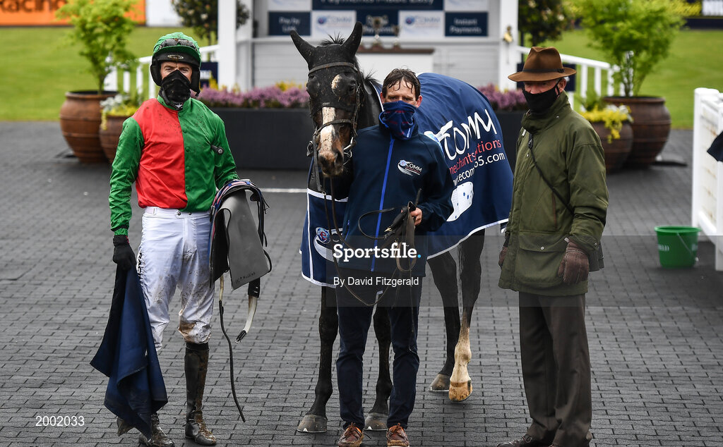 27 April 2021; Jockey Patrick Mullins with horse Echoes in Rain, trainer and father Willie Mullins and stablehand Donal Redmond after winning the eCOMM Merchant Solutions Champion Novice Hurdle during day one of the Punchestown Festival at Punchestown Racecourse in Kildare. Photo by David Fitzgerald/Sportsfile
