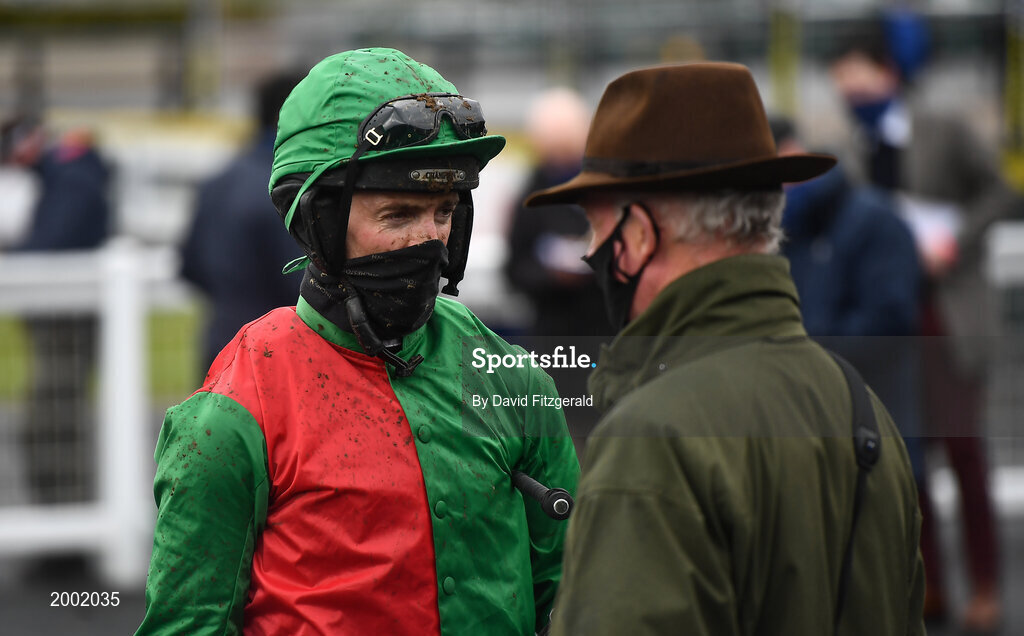 27 April 2021; Jockey Patrick Mullins speaks with trainer and father Willie Mullins after winning the eCOMM Merchant Solutions Champion Novice Hurdle during day one of the Punchestown Festival at Punchestown Racecourse in Kildare. Photo by David Fitzgerald/Sportsfile