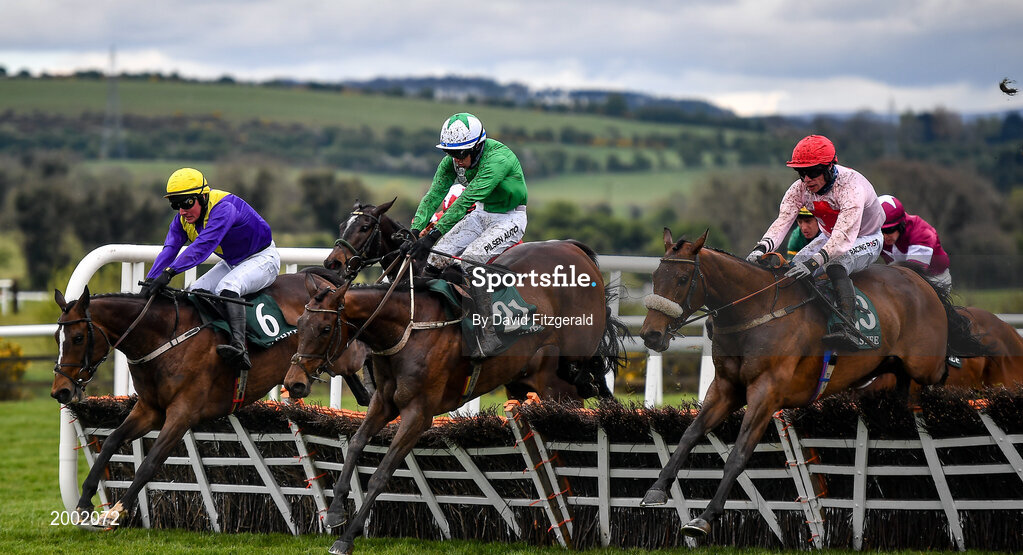 27 April 2021; Jazzaway, with Conor McNamara up, centre, jumps the last alongside eventual second place Whiskey Sour, with Hugh Morgan up, left, and Arcadian Sunrise, with Denis O'Regan, right, on their way to winning the Killashee Hotel Handicap Hurdle during day one of the Punchestown Festival at Punchestown Racecourse in Kildare. Photo by David Fitzgerald/Sportsfile