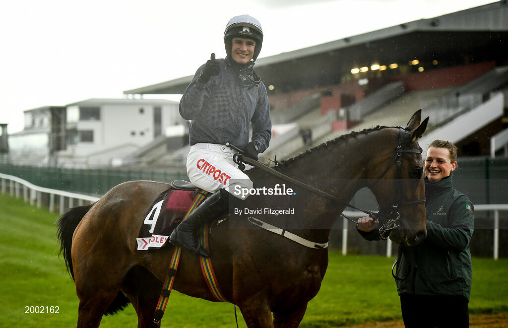 27 April 2021; Jockey Danny Mullins celebrates on Colreevy, with stablehand Amy Morissey, after winning the Dooley Insurance Champion Novice Steeplechase during day one of the Punchestown Festival at Punchestown Racecourse in Kildare. Photo by David Fitzgerald/Sportsfile