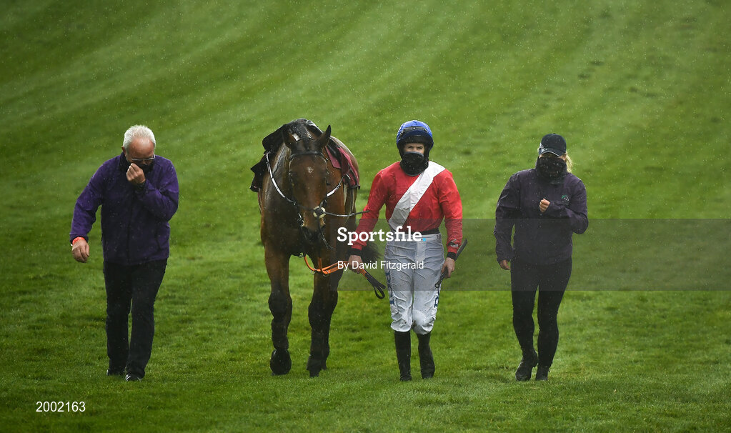 27 April 2021; Jockey Rachael Blackmore walks back with Envoi Allen after they pulled up during the Dooley Insurance Group Champion Novice Steeplechase during day one of the Punchestown Festival at Punchestown Racecourse in Kildare. Photo by David Fitzgerald/Sportsfile