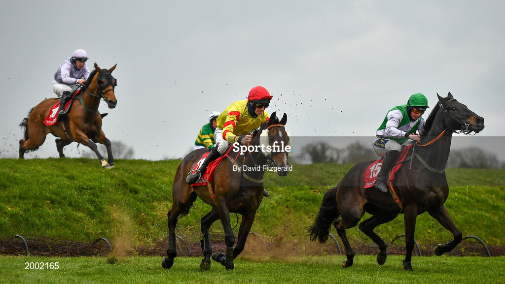 27 April 2021; Singing Banjo, with Barry John Walsh, left, clear Rubys Double alongside Vital Island, with Jamie Codd up, on their way to winning way to winning the Kildare Hunt Club Fr Sean Breen Memorial Steeplechase during day one of the Punchestown Festival at Punchestown Racecourse in Kildare. Photo by David Fitzgerald/Sportsfile
