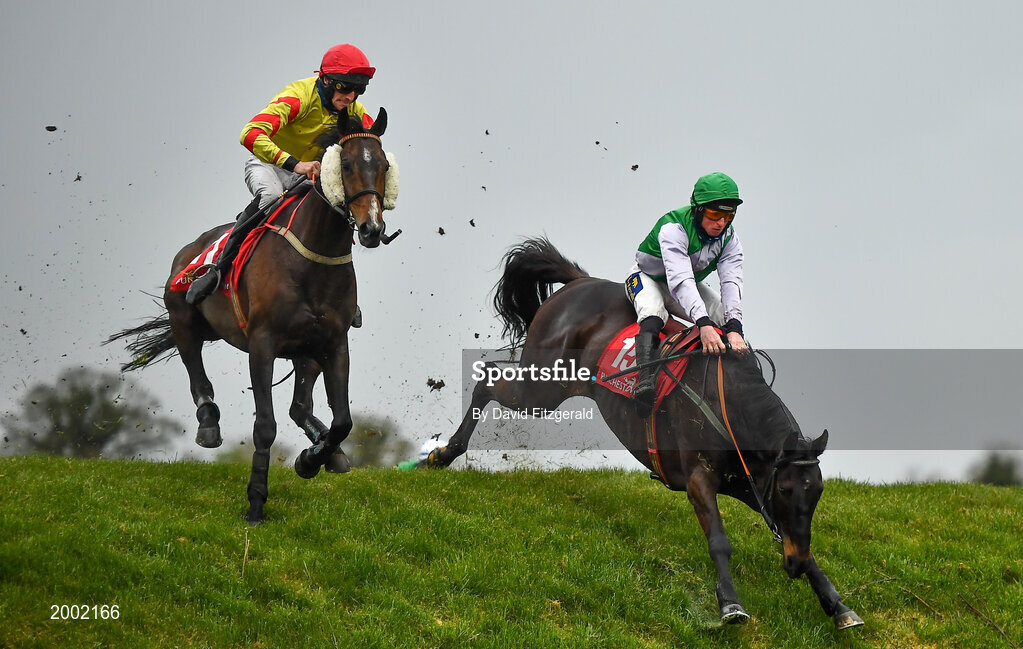 27 April 2021; Singing Banjo, with Barry John Walsh, left, clear Rubys Double alongside Vital Island, with Jamie Codd up, on their way to winning way to winning the Kildare Hunt Club Fr Sean Breen Memorial Steeplechase during day one of the Punchestown Festival at Punchestown Racecourse in Kildare. Photo by David Fitzgerald/Sportsfile