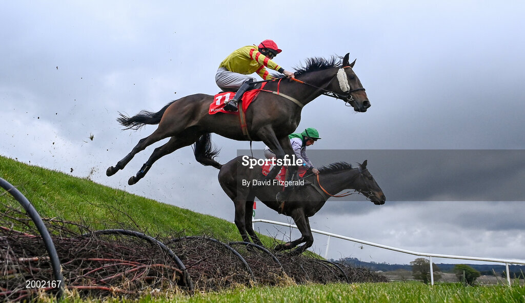27 April 2021; Singing Banjo, with Barry John Walsh, left, clear Rubys Double alongside Vital Island, with Jamie Codd up, on their way to winning way to winning the Kildare Hunt Club Fr Sean Breen Memorial Steeplechase during day one of the Punchestown Festival at Punchestown Racecourse in Kildare. Photo by David Fitzgerald/Sportsfile
