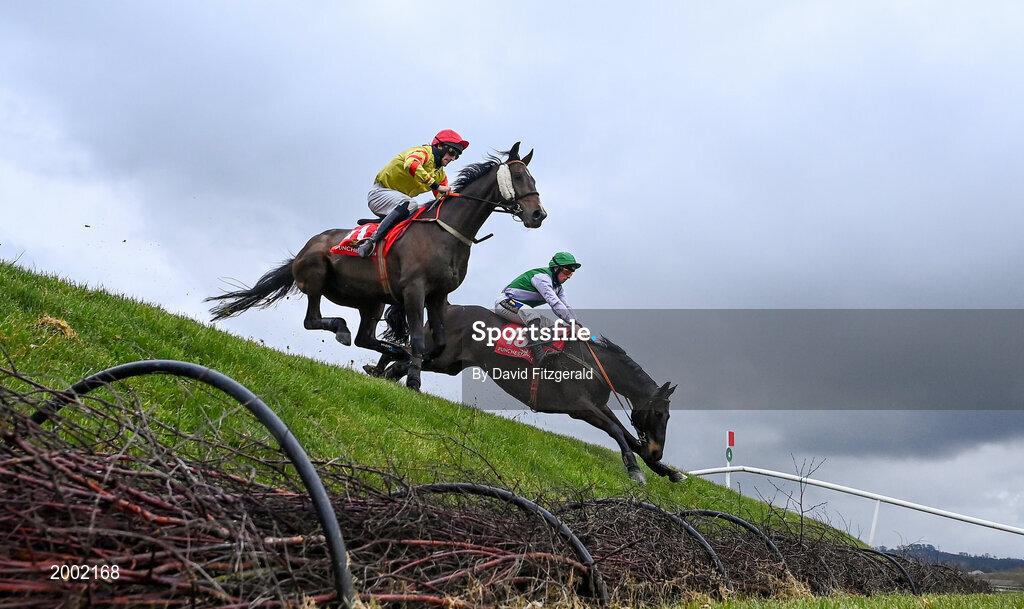 27 April 2021; Singing Banjo, with Barry John Walsh, left, clear Rubys Double alongside Vital Island, with Jamie Codd up, on their way to winning way to winning the Kildare Hunt Club Fr Sean Breen Memorial Steeplechase during day one of the Punchestown Festival at Punchestown Racecourse in Kildare. Photo by David Fitzgerald/Sportsfile
