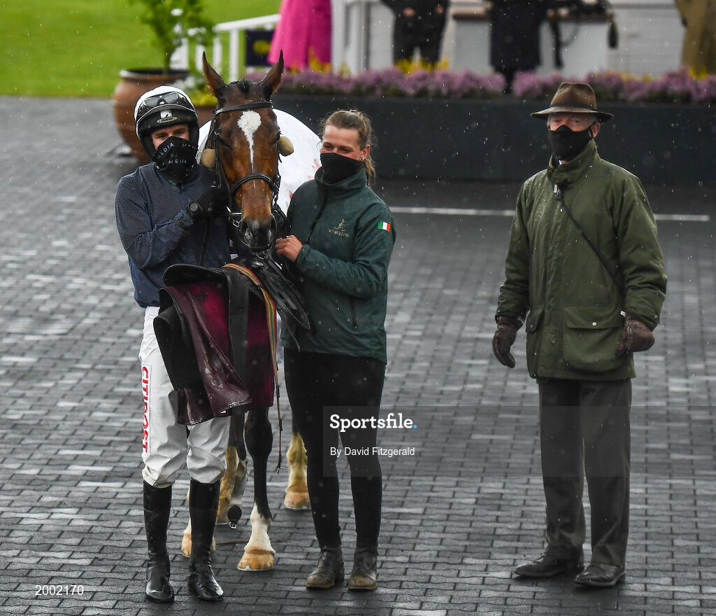 27 April 2021; Jockey Danny Mullins with Colreevy, stablehand Amy Morrissey and trainer Willie Mullins after winning the Dooley Insurance Group Champion Novice Steeplechase during day one of the Punchestown Festival at Punchestown Racecourse in Kildare. Photo by David Fitzgerald/Sportsfile