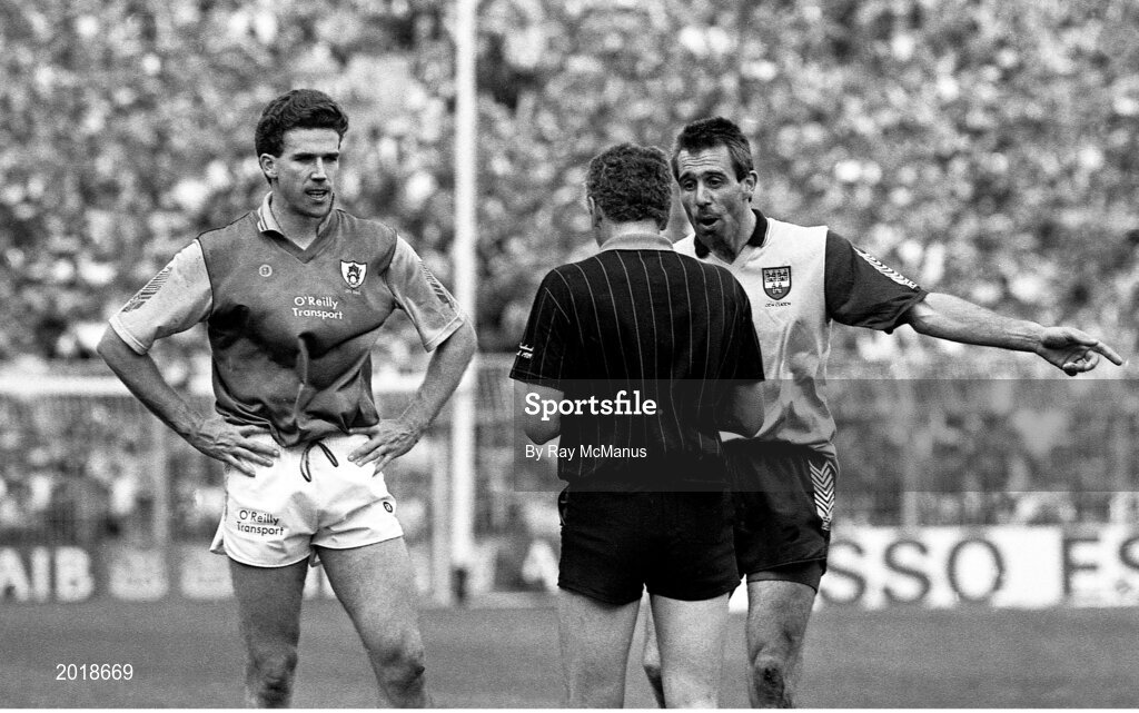 2 June 1991; Liam Hayes of Meath, left, and Dave Foran of Dublin are spoken to by referee Tommy Howard during the Leinster Senior Football Championship Preliminary Round match between Dublin and Meath at Croke Park in Dublin. Photo by Ray McManus/Sportsfile