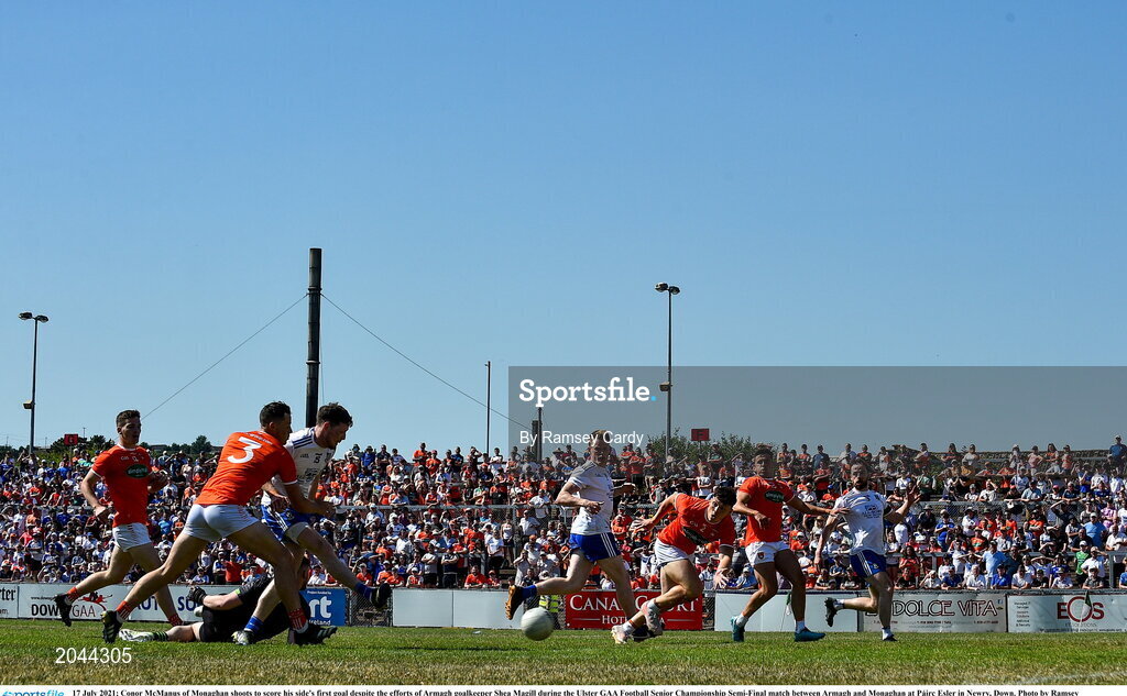 17 July 2021; Conor McManus of Monaghan shoots to score his side's first goal despite the efforts of Armagh goalkeeper Shea Magill during the Ulster GAA Football Senior Championship Semi-Final match between Armagh and Monaghan at Páirc Esler in Newry, Down. Photo by Ramsey Cardy/Sportsfile