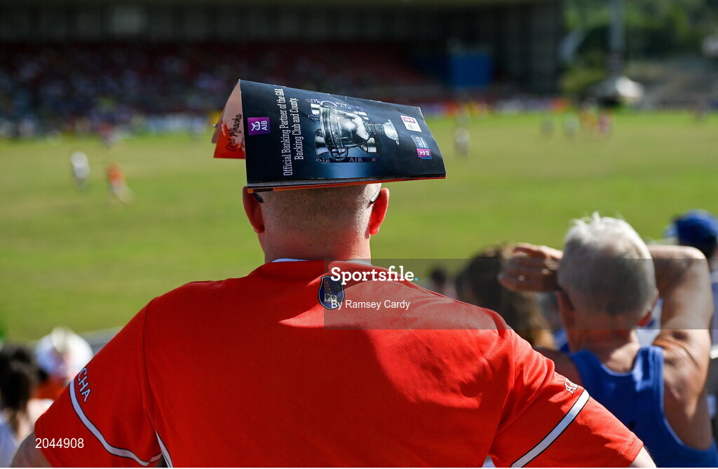 17 July 2021; An Armagh supporter takes shelter from the sun with a match programme during the Ulster GAA Football Senior Championship Semi-Final match between Armagh and Monaghan at Páirc Esler in Newry, Down. Photo by Ramsey Cardy/Sportsfile