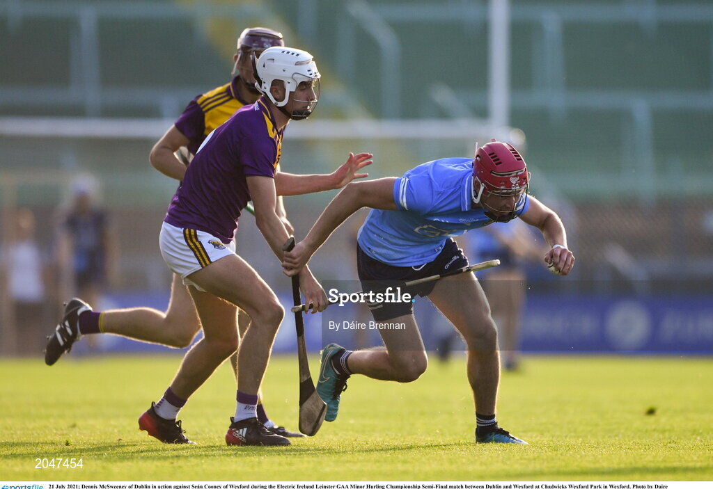21 July 2021; Dennis McSweeney of Dublin in action against Seán Cooney of Wexford during the Electric Ireland Leinster GAA Minor Hurling Championship Semi-Final match between Dublin and Wexford at Chadwicks Wexford Park in Wexford. Photo by Daire Brennan/Sportsfile