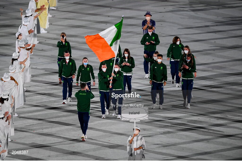 23 July 2021; Light heavyweight Emmet Brennan uses his phone to record proceedings as Team Ireland flagbearers Kellie Harrington, right, and Brendan Irvine carry the Irish tricolour during the 2020 Tokyo Summer Olympic Games opening ceremony at the Olympic Stadium in Tokyo, Japan. Photo by Stephen McCarthy/Sportsfile