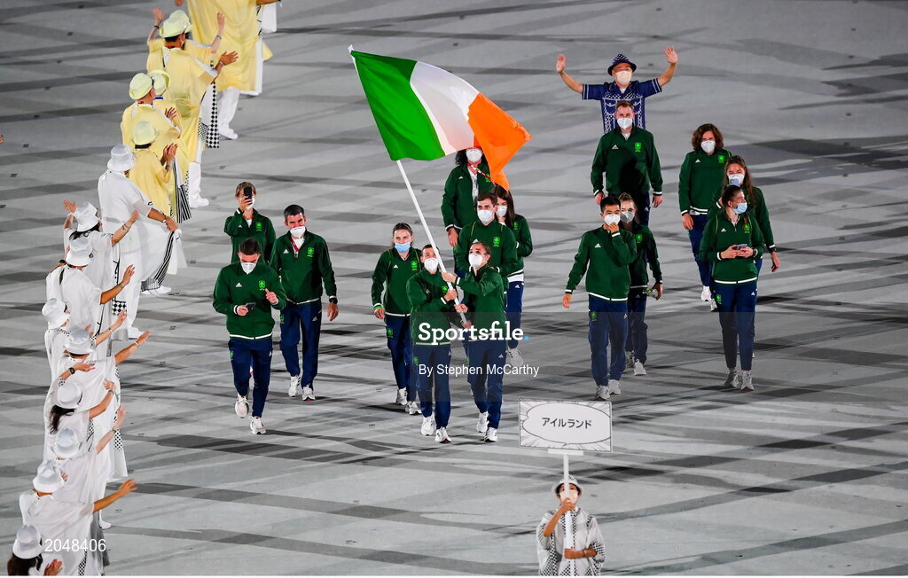 23 July 2021; Team Ireland flagbearers Kellie Harrington, right, and Brendan Irvine carry the Irish tricolour during the 2020 Tokyo Summer Olympic Games opening ceremony at the Olympic Stadium in Tokyo, Japan. Photo by Stephen McCarthy/Sportsfile