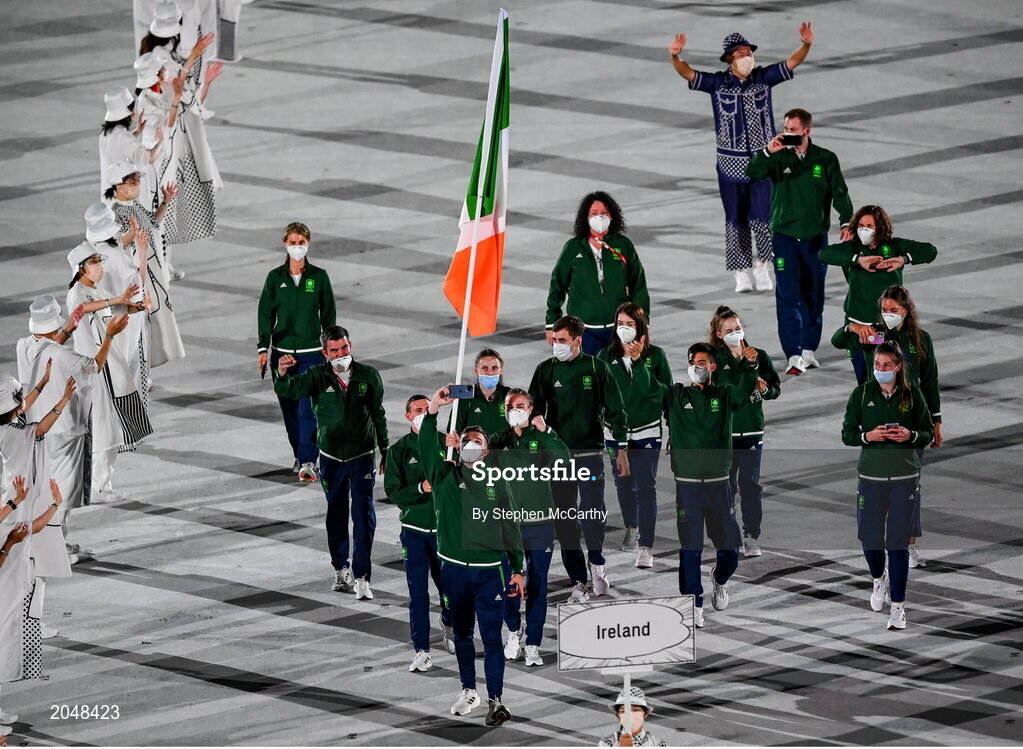 23 July 2021; Light heavyweight Emmet Brennan uses his phone to take a picture as Team Ireland flagbearers Kellie Harrington, right, and Brendan Irvine carry the Irish tricolour during the 2020 Tokyo Summer Olympic Games opening ceremony at the Olympic Stadium in Tokyo, Japan. Photo by Stephen McCarthy/Sportsfile