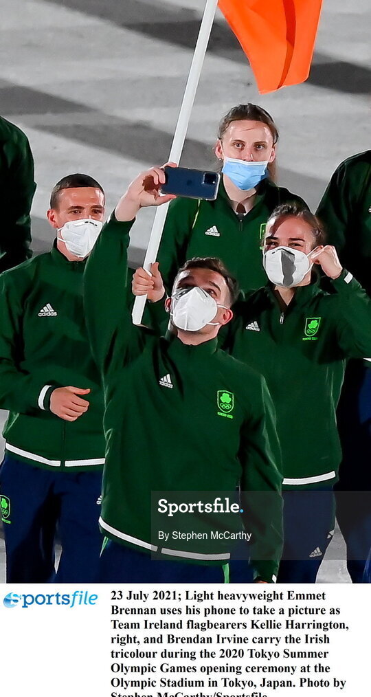 23 July 2021; Light heavyweight Emmet Brennan uses his phone to take a picture as Team Ireland flagbearers Kellie Harrington, right, and Brendan Irvine carry the Irish tricolour during the 2020 Tokyo Summer Olympic Games opening ceremony at the Olympic Stadium in Tokyo, Japan. Photo by Stephen McCarthy/Sportsfile