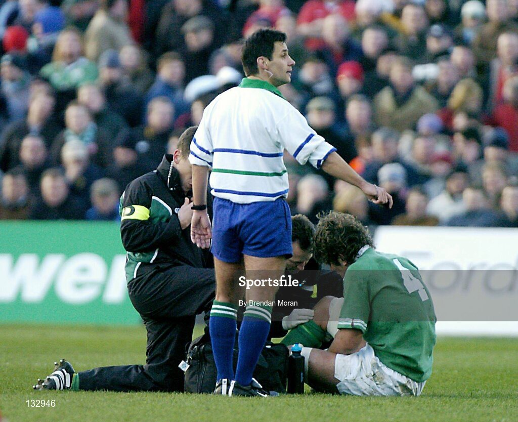 22 February 2004; Donnacha O'Callaghan, Ireland, has his knee attended to by team physio Ailbe McCormack and Dr Gary O'Driscoll, before being substituted. RBS 6 Nations Championship 2003-2004, Ireland v Wales, Lansdowne Road, Dublin. Picture credit; Brendan Moran / SPORTSFILE *EDI*