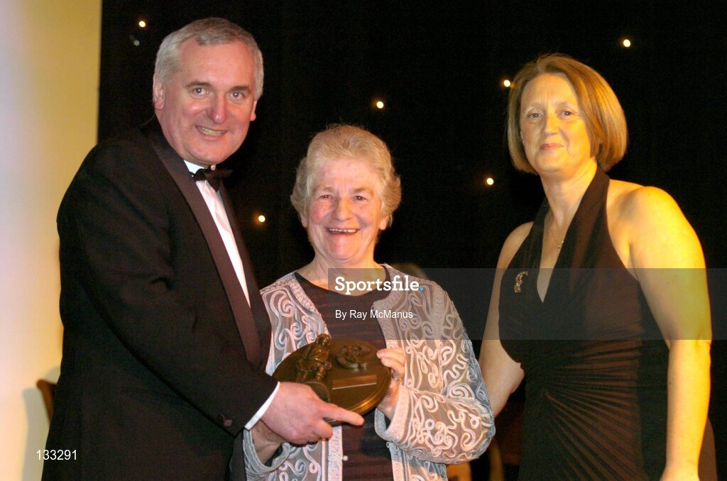 28 February 2004; Nancy McCarthy, on behalf of the late Sophie Brack, her sister, who was named on the Camogie team of the Century, with An Taoiseach, Bertie Ahern, TD, and Miriam O'Callaghan, Uachtaran, Cumann Camogaiochta na nGael, at the Cumann Camogaiochta na nGael centenary celebrations at the Citywest Hotel, Dublin. Picture credit; Ray McManus / SPORTSFILE *EDI*