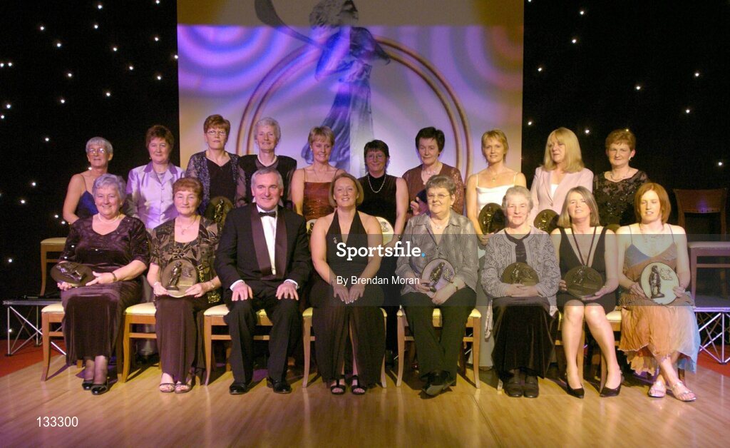 28 February 2004; The Camogie team of the Century, back row from left, Sheila Wallace, Ard Stiurthoir, Cumann Camogaiochta na nGael, Liz Neary, Kilkenny, Marie Costine O'Donovan, Cork, Mary Sinnott Dinan, Wexford, Bridie Martin McGarry, Kilkenny, Sandie Fizgibbon, Cork, Margaret O'Leary Leacy, Wexford, Linda Mellerick, Cork, Marian Carolan, on behalf of the late Kathleen Mills Hill, Dublin, and Mary Fennelly, on behalf of Angela Downey Browne, Kilkenny, and front row, from left, Eileen Duffy O'Mahony, Dublin, Mairead McAtamney Magill, Antrim,  An Taoiseach, Bertie Ahern, T.D, Miriam O'Callaghan, Uachtaran, Cumann Camogaiochta na nGael, Una O'Connor, Dublin, Nancy McCarthy, on behalf of the late Sophie Brack, her sister, Pat Moloney Lenihan, Cork, and Deirdre Hughes, Tipperary, at the Cumann Camogaiocht na nGael centenary celebrations at the Citywest Hotel, Dublin. Picture credit; Brendan Moran / SPORTSFILE *EDI*
