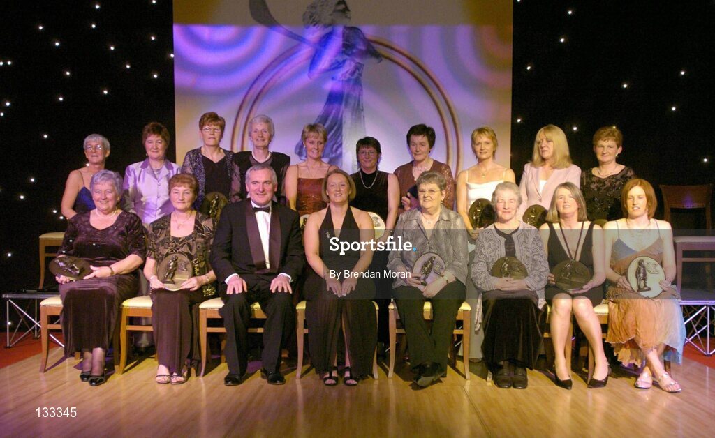 28 February 2004; The Camogie team of the Century, back row from left, Sheila Wallace, Ard Stiurthoir, Cumann Camogaiochta na nGael, Liz Neary, Kilkenny, Marie Costine O'Donovan, Cork, Mary Sinnott Dinan, Wexford, Bridie Martin McGarry, Kilkenny, Sandie Fizgibbon, Cork, Margaret O'Leary Leacy, Wexford, Linda Mellerick, Cork, Marian Carolan, on behalf of the late Kathleen Mills Hill, Dublin, and Mary Fennelly, on behalf of Angela Downey Browne, Kilkenny, and front row, from left, Eileen Duffy O'Mahony, Dublin, Mairead McAtamney Magill, Antrim,  An Taoiseach, Bertie Ahern, T.D, Miriam O'Callaghan, Uachtaran, Cumann Camogaiochta na nGael, Una O'Connor, Dublin, Nancy McCarthy, on behalf of the late Sophie Brack, her sister, Pat Moloney Lenihan, Cork, and Deirdre Hughes, Tipperary, at the Cumann Camogaiocht na nGael centenary celebrations at the Citywest Hotel, Dublin. Picture credit; Brendan Moran / SPORTSFILE *EDI*
