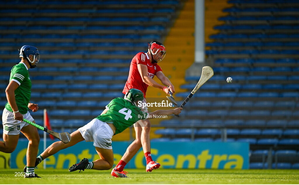 27 July 2021; Ben Nyhan of Cork has a shot on goal despite the efforts of William Dore of Limerick during the Electric Ireland Munster GAA Minor Hurling Championship Semi-Final match between Limerick and Cork at Semple Stadium in Thurles, Tipperary. Photo by Eóin Noonan/Sportsfile