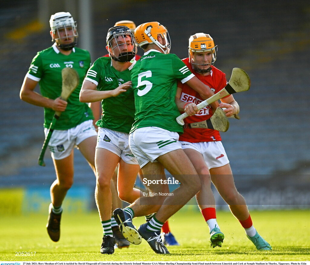 27 July 2021; Rory Sheahan of Cork is tackled by David Fitzgerald of Limerick during the Electric Ireland Munster GAA Minor Hurling Championship Semi-Final match between Limerick and Cork at Semple Stadium in Thurles, Tipperary. Photo by Eóin Noonan/Sportsfile