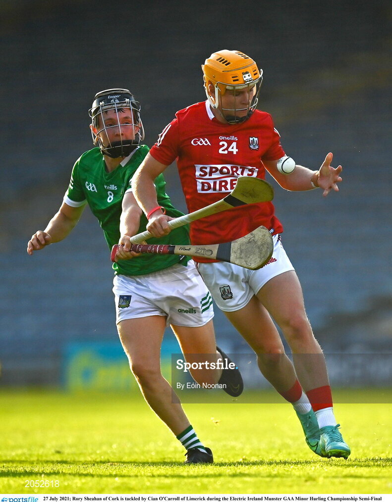 27 July 2021; Rory Sheahan of Cork is tackled by Cian O'Carroll of Limerick during the Electric Ireland Munster GAA Minor Hurling Championship Semi-Final match between Limerick and Cork at Semple Stadium in Thurles, Tipperary. Photo by Eóin Noonan/Sportsfile