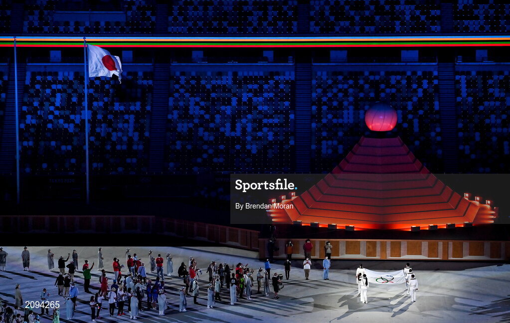 23 July 2021; The flag of the International Olympic Committee is brought to be raised and flown during the 2020 Tokyo Summer Olympic Games opening ceremony at the Olympic Stadium in Tokyo, Japan. Photo by Brendan Moran/Sportsfile