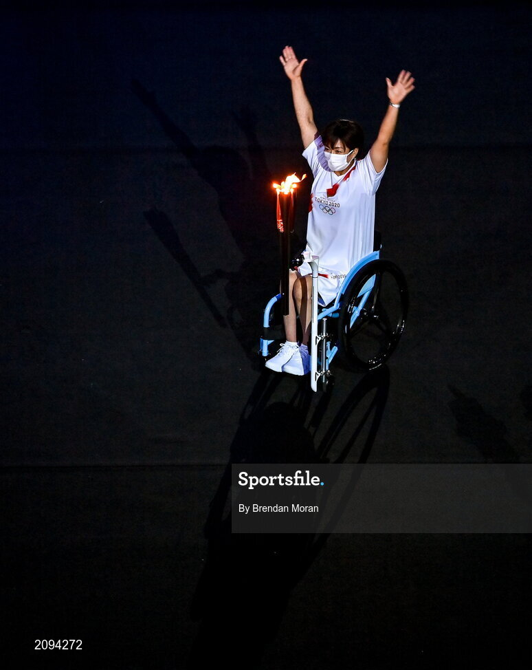 23 July 2021; Paralympic athlete Wakako Tsuchida carries the Olympic torch during the 2020 Tokyo Summer Olympic Games opening ceremony at the Olympic Stadium in Tokyo, Japan. Photo by Brendan Moran/Sportsfile