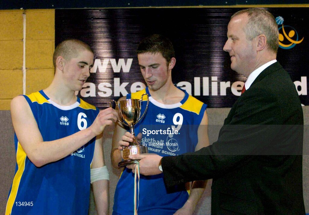 23 March 2004; St. Patrick's Comprehensive captain Gavin Smith (9) and team-mate Barry Leamy are presented with the cup by Martin Hehir, Schools Development Officer of Basketball Ireland. All-Ireland Schoolboys Basketball League, U19 'C'  Final, St Aidan's, Cootehill, Co. Cavan v St Patrick's Comprehensive, Shannon, Co. Clare, ESB Arena, Tallaght, Dublin. Picture credit; Brendan Moran / SPORTSFILE *EDI*