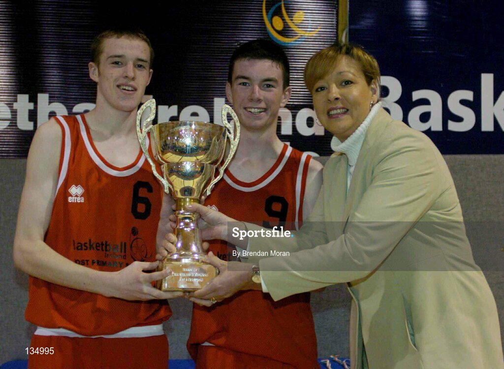 24 March 2004; St Fintan's co-captains Darren O'Moore, left, and Michael Chubb are presented with the cup by Debbie Massey, Chief Executive, Basketball Ireland. All-Ireland Schoolboys Basketball League, U16 'A'  Final, St Joseph's Patrician College, Galway v St Fintan's, Sutton, Dublin, ESB Arena, Tallaght, Dublin. Picture credit; Brendan Moran / SPORTSFILE *EDI*