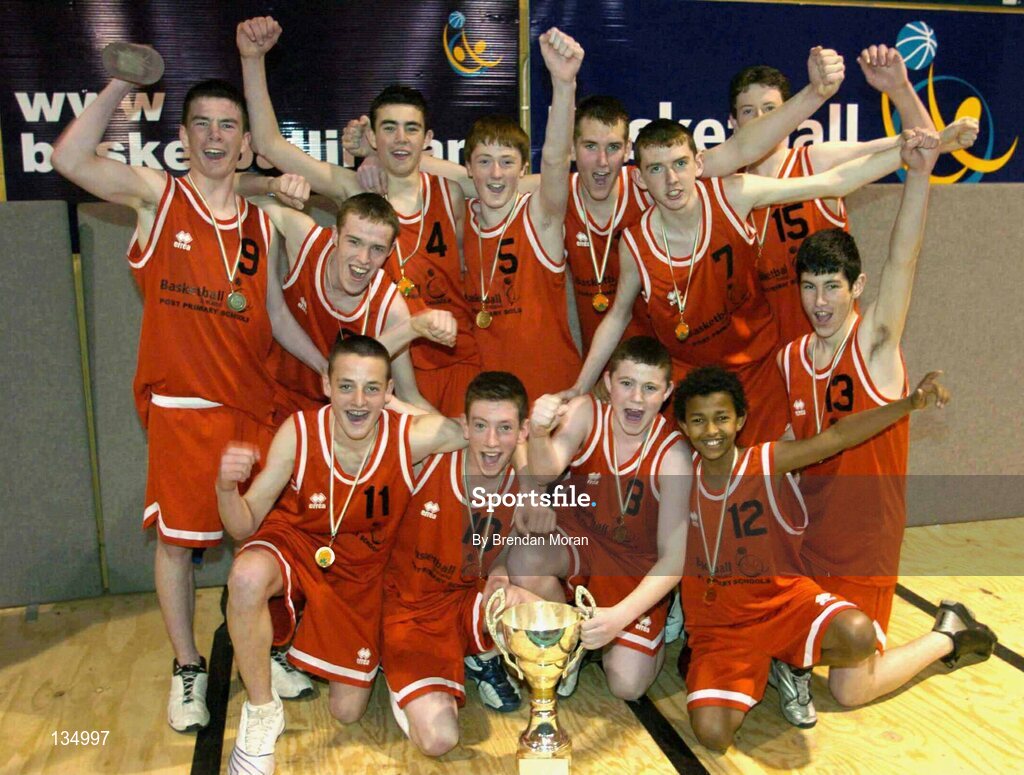 24 March 2004; The team from St Fintan's, Sutton, celebrate with the cup after the game. All-Ireland Schoolboys Basketball League, U16 'A'  Final, St Joseph's Patrician College, Galway v St Fintan's, Sutton, Dublin, ESB Arena, Tallaght, Dublin. Picture credit; Brendan Moran / SPORTSFILE *EDI*