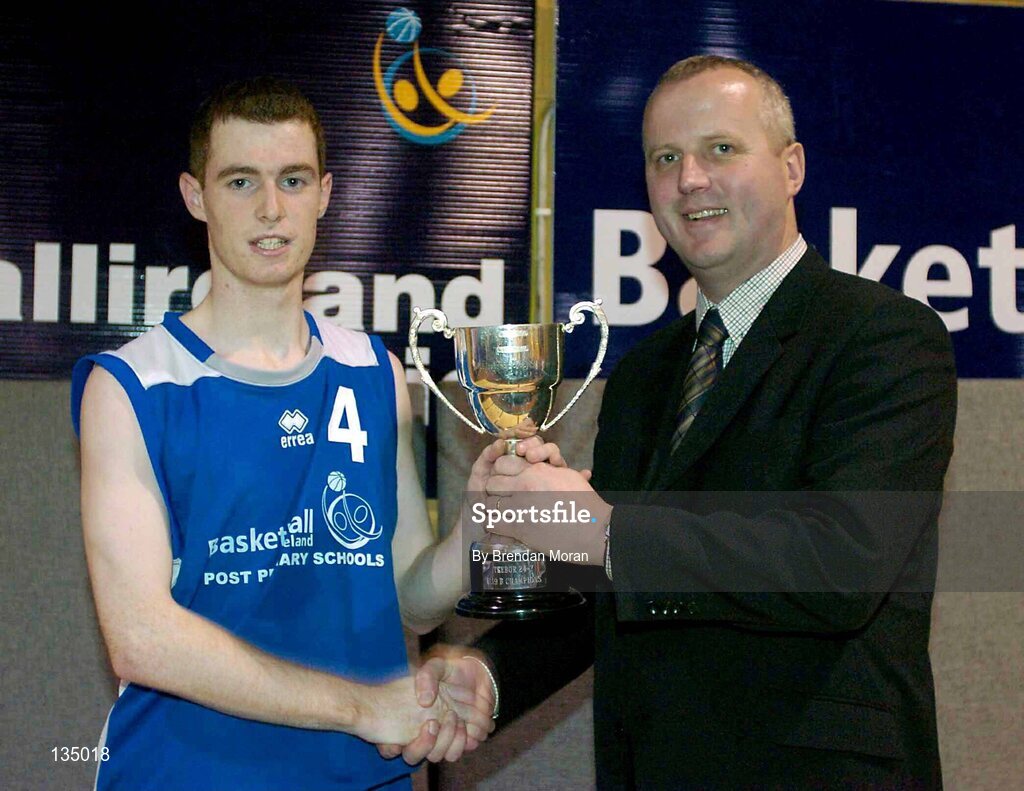 24 March 2004; Mercy Mounthawk captain Brian Mulcahy is presented with the cup by Martin Hehir, Schools Development Officer of Basketball Ireland. All-Ireland Schoolboys Basketball League, U19 'B'  Final, Malahide Community School, Dublin v Mercy Mounthawk, Tralee, Co. Kerry, ESB Arena, Tallaght, Dublin. Picture credit; Brendan Moran / SPORTSFILE *EDI*
