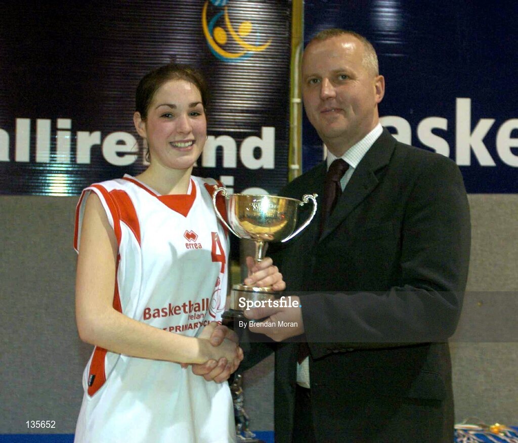 30 March 2004; Salesians captain Rebecca Fitzgerald receives the cup from Martin Hehir, Schools Development Officer of Basketball Ireland. All - Ireland Schoolgirls Basketball League, Senior 'C' Final, Salesians, Limerick, v Killarney Community College, Kerry, ESB Arena, Tallaght, Dublin. Picture credit; Brendan Moran / SPORTSFILE *EDI*