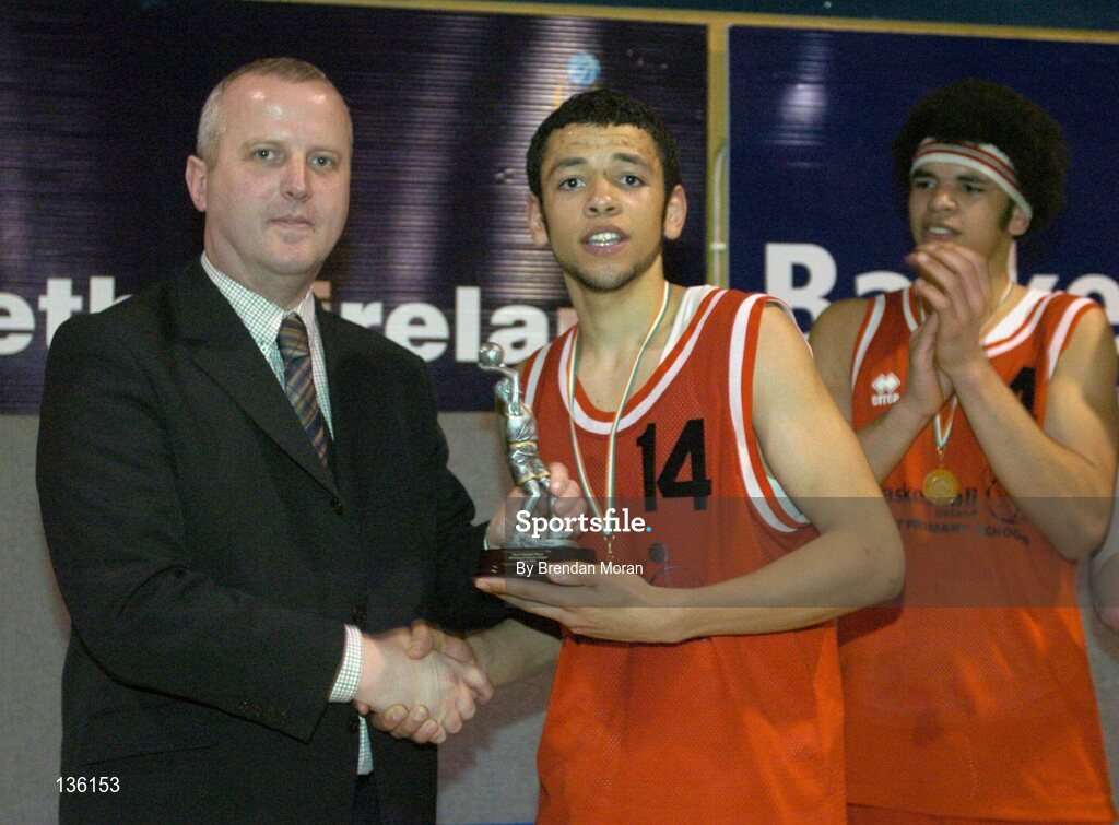 24 March 2004; Isaac Westbrooks, St Fintan's, receives the MVP from Martin Hehir, Schools Development Officer of Basketball Ireland. All-Ireland Schoolboys Basketball League, U19 'A'  Final, St Fintan's, Sutton, Dublin v North Monastery, Cork, ESB Arena, Tallaght, Dublin. Picture credit; Brendan Moran / SPORTSFILE *EDI*